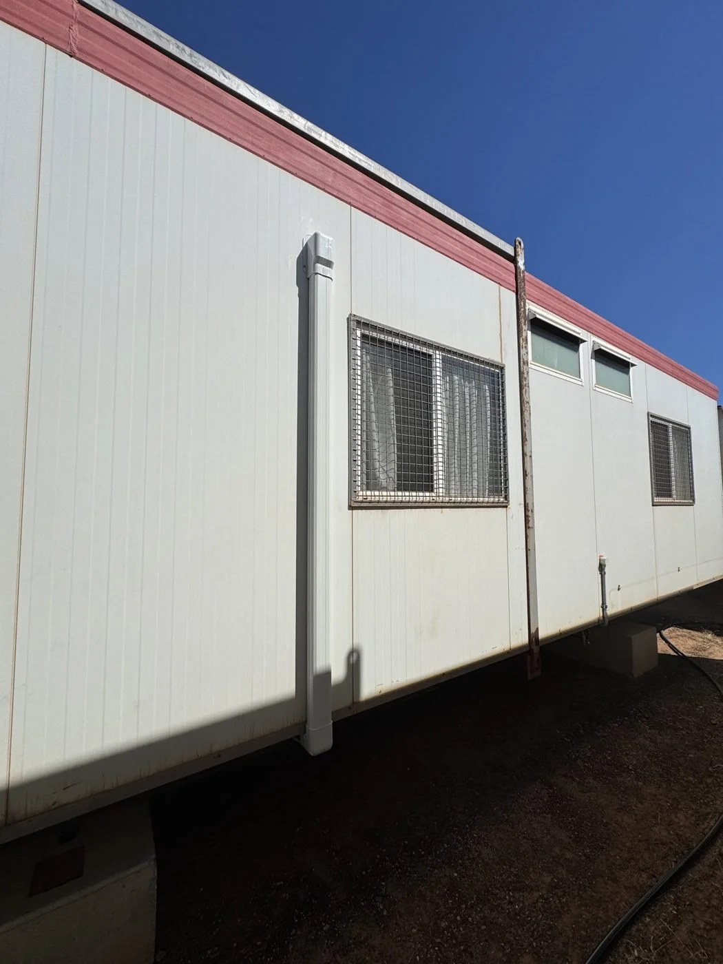Neat pipe ducting on a remote transportable building