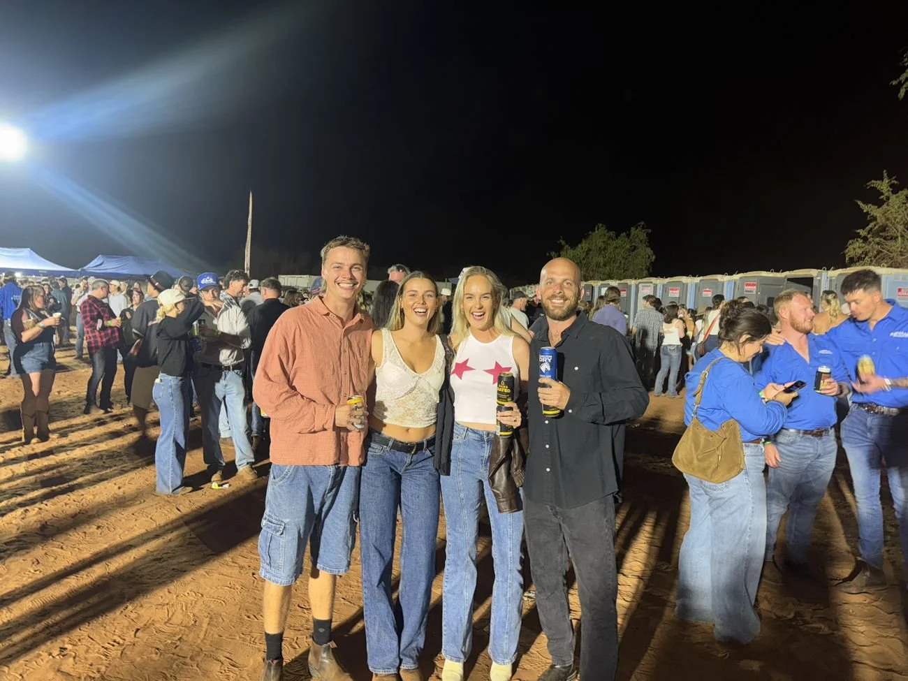 The team out at a country rodeo at night