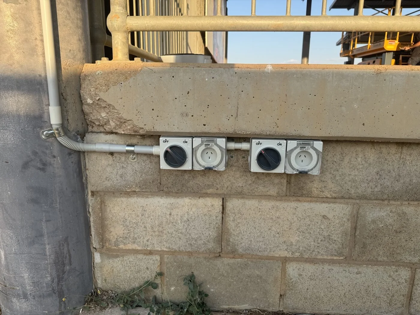 Switched weatherproof outlets in conduit on a block wall