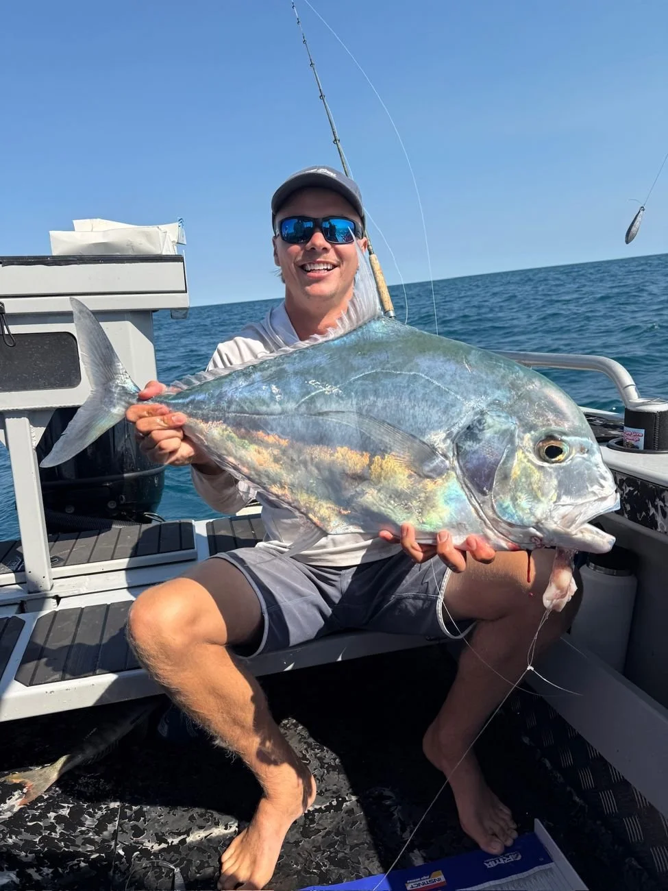 One of the crew holding a big trevally caught off Broome