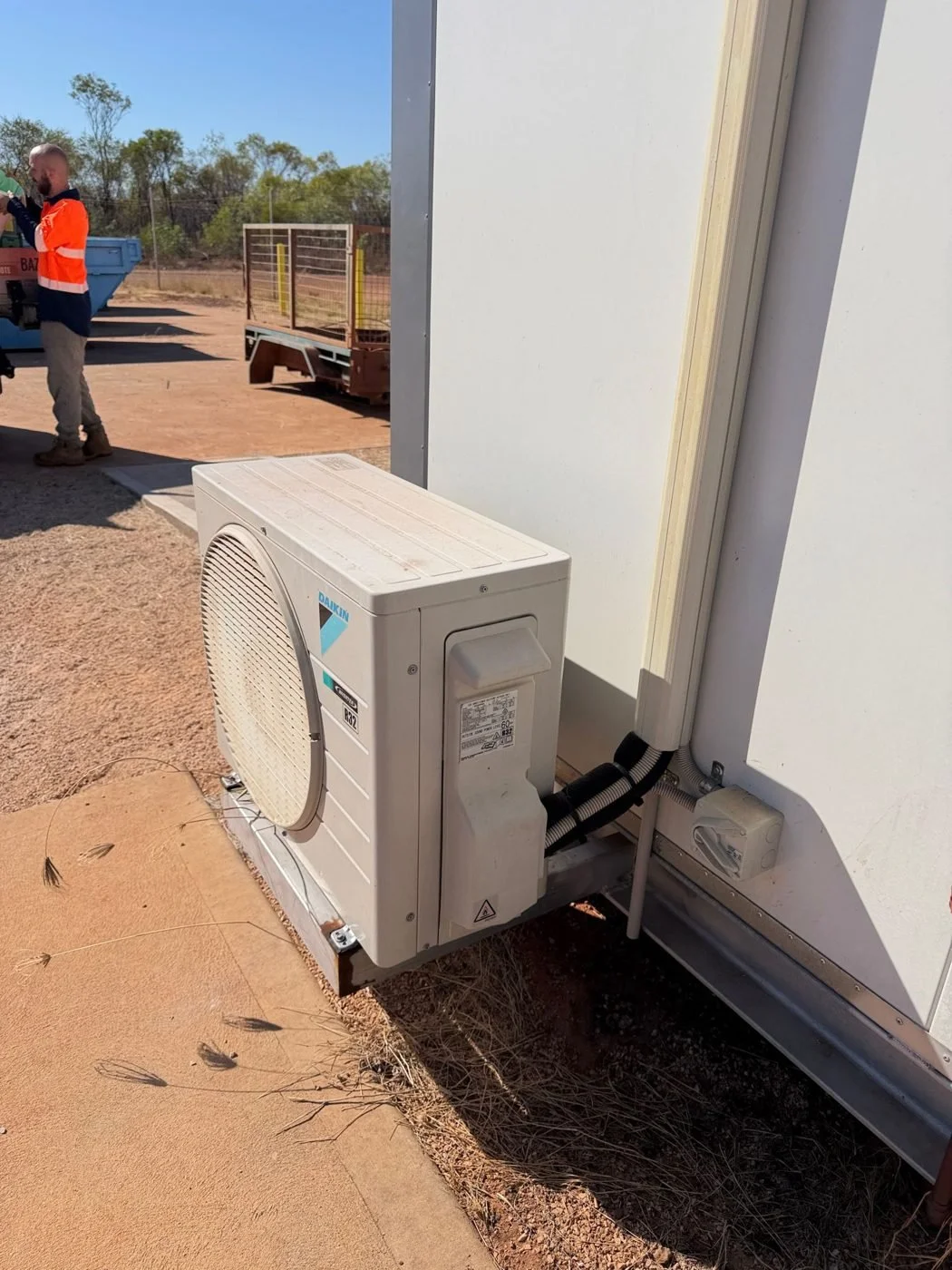 Bazlec West technician on a remote site with a new condenser install