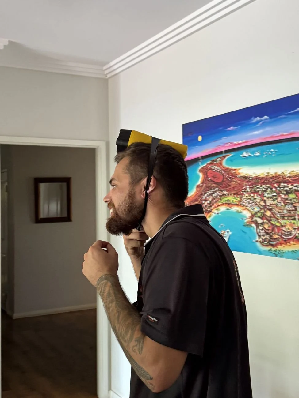 A crew member trying on a head torch in the office