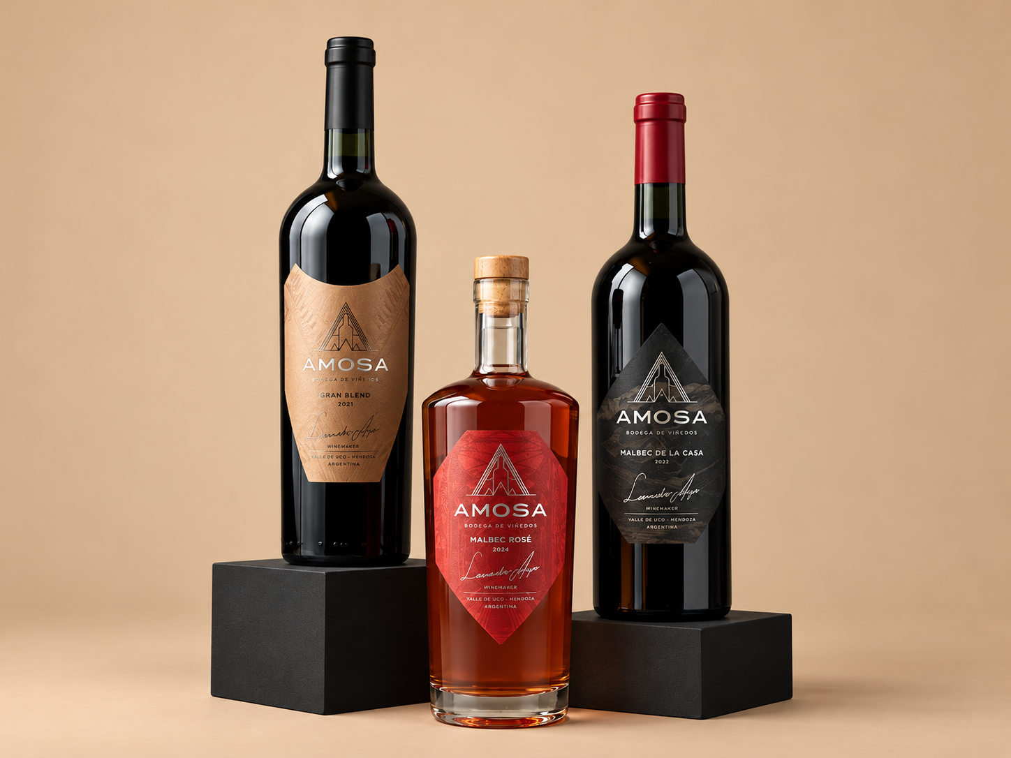 Three AMOSA wine bottles on black display pedestals