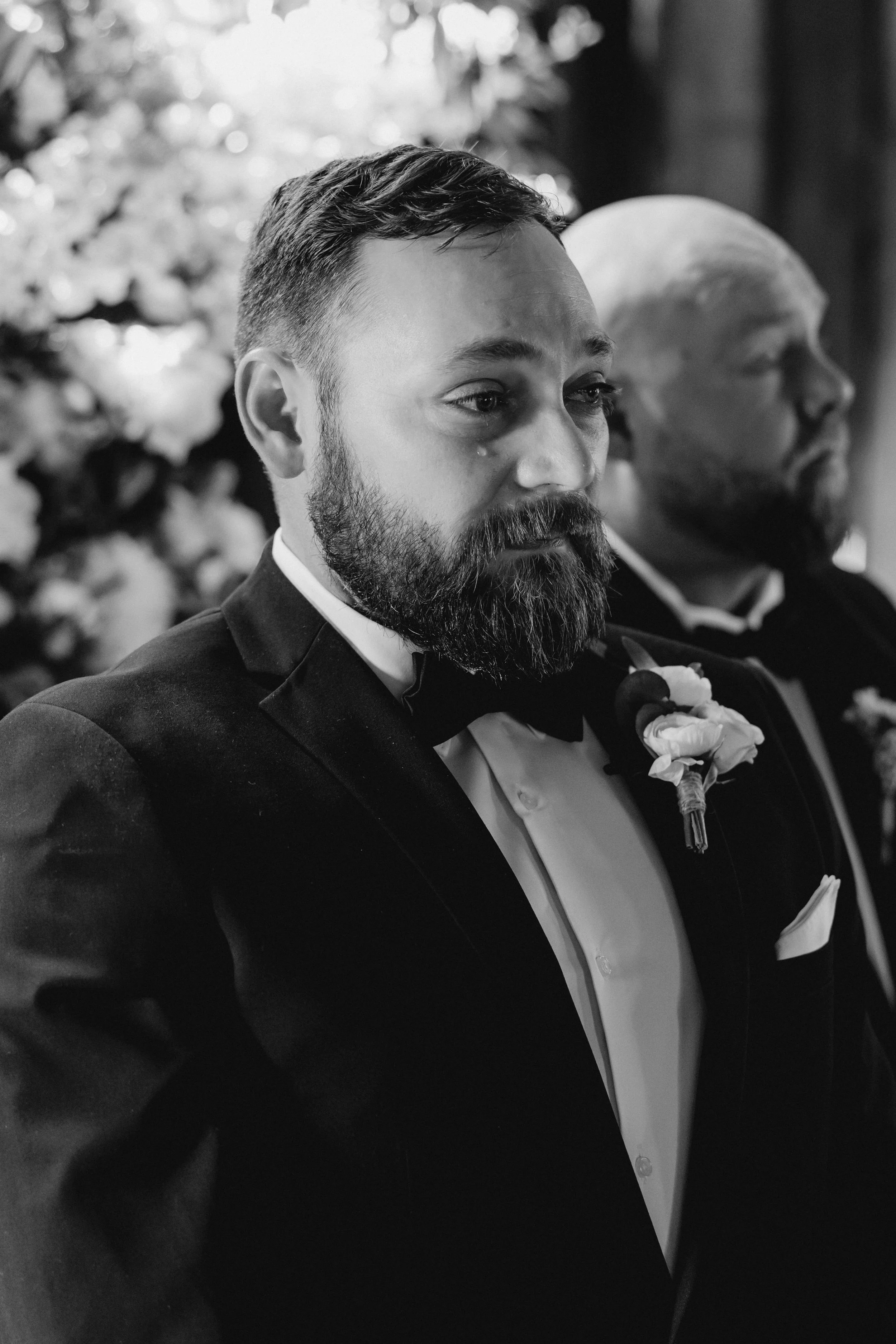 Groom with teary eyes watching his bride during their wedding ceremony