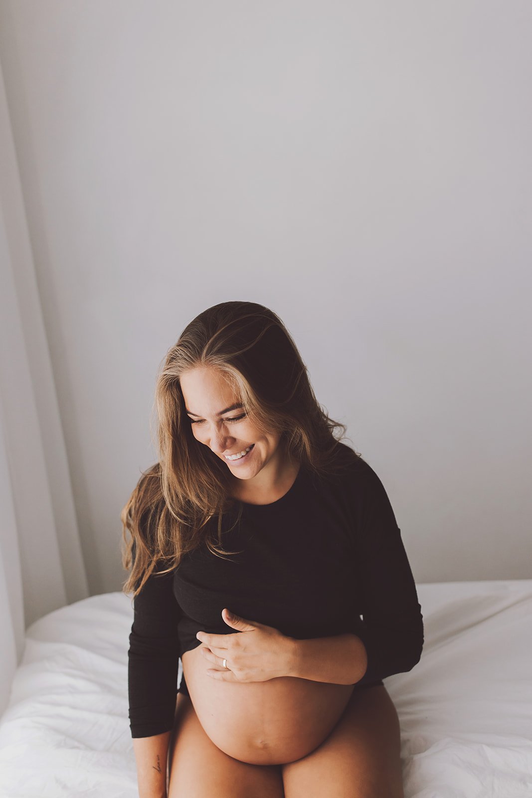Playful family maternity photo by Nicole Butler Photography