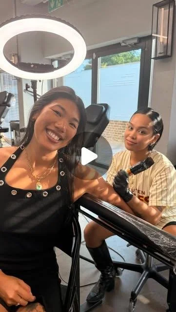 Kimberley tattooing a smiling client