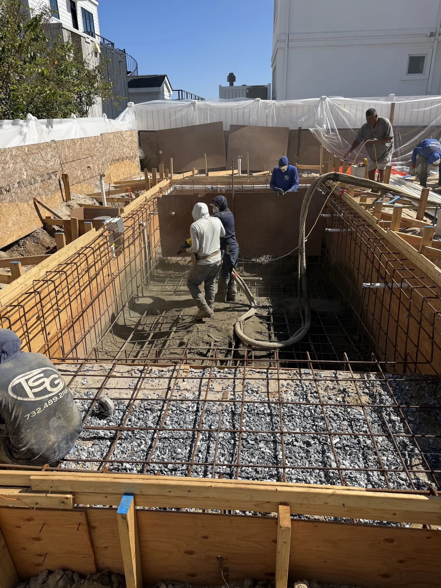 Crew placing steel and concrete for a new pool in Longport, NJ