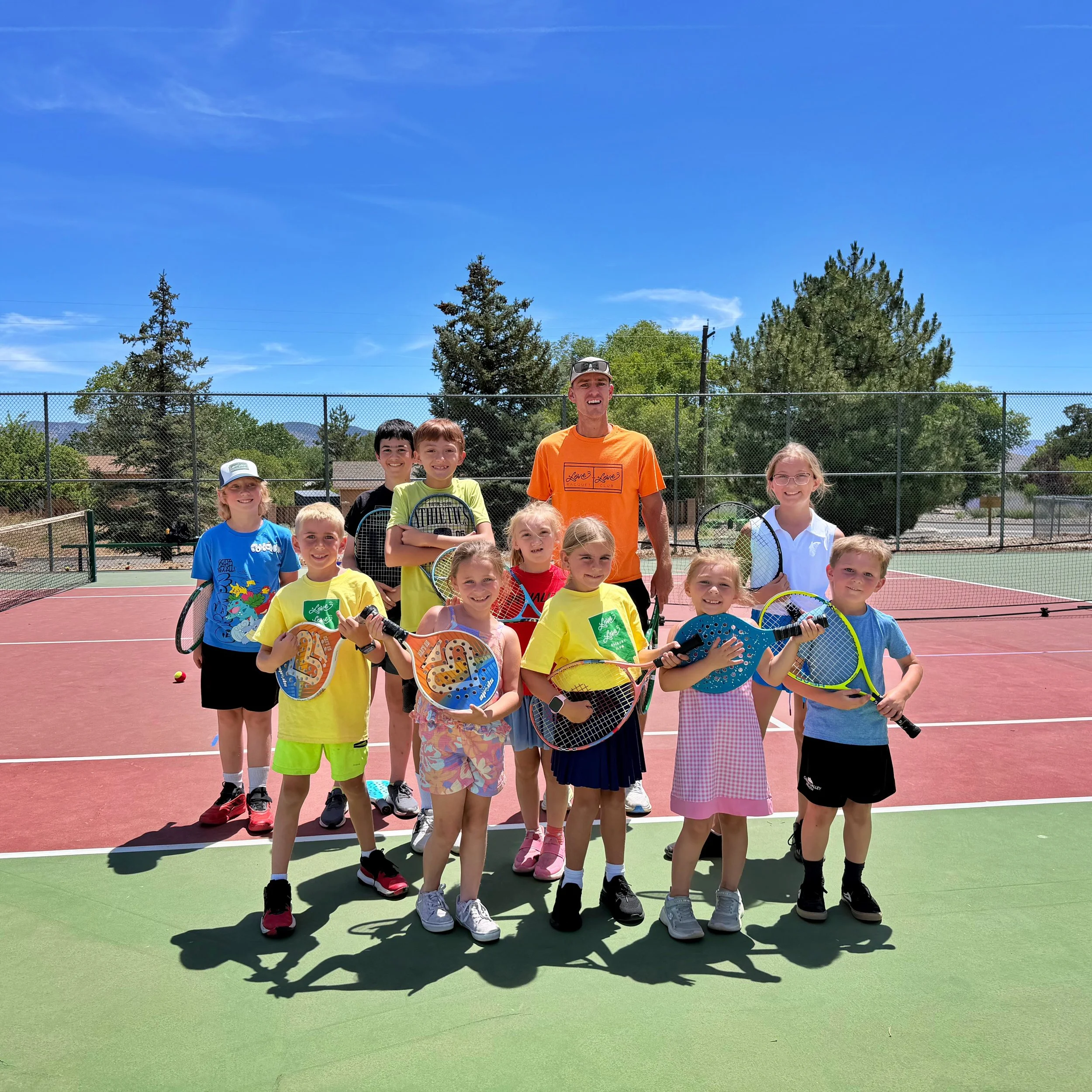 Children enjoying a junior tennis class