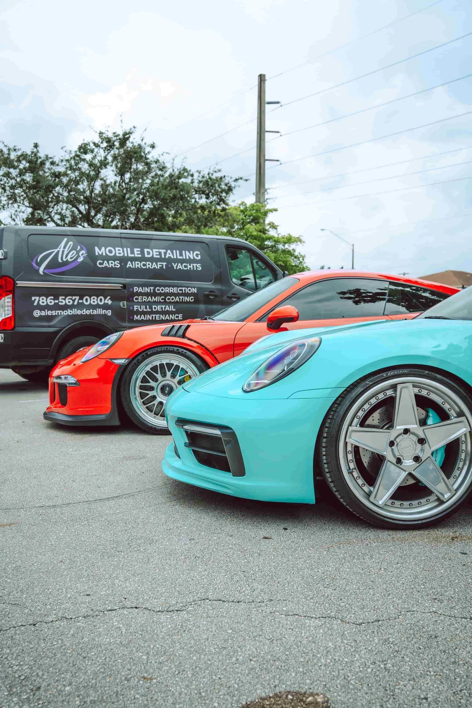 Ale's Mobile Detailing van beside Porsche vehicles in South Florida