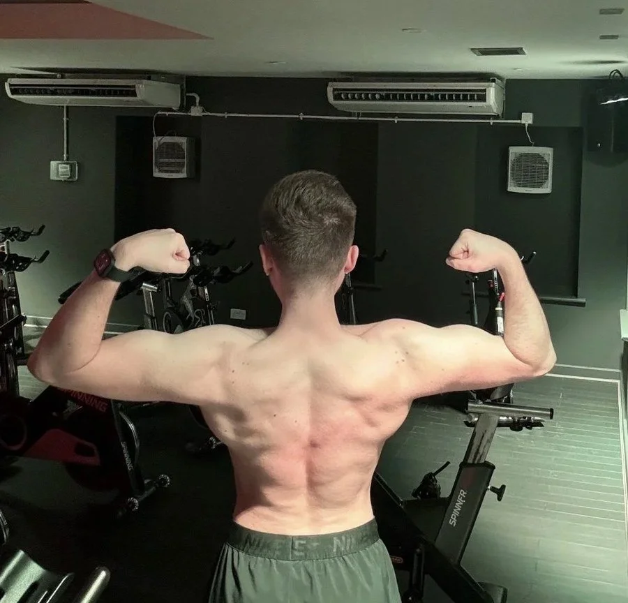 After training with Luke: the same client’s back pose in a gym