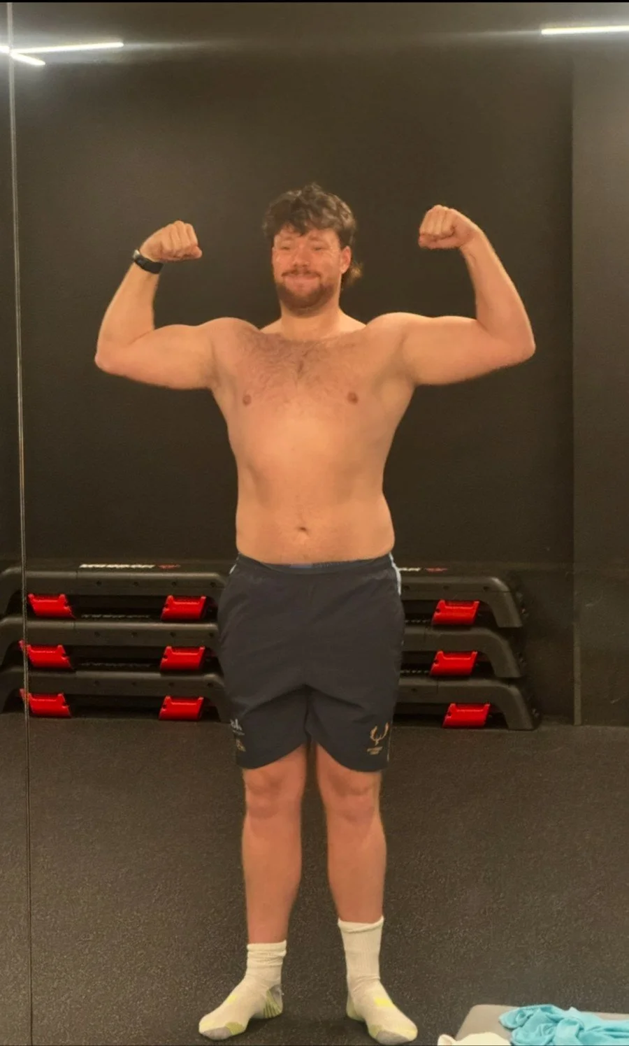 Before training with Luke: client flexing in a gym