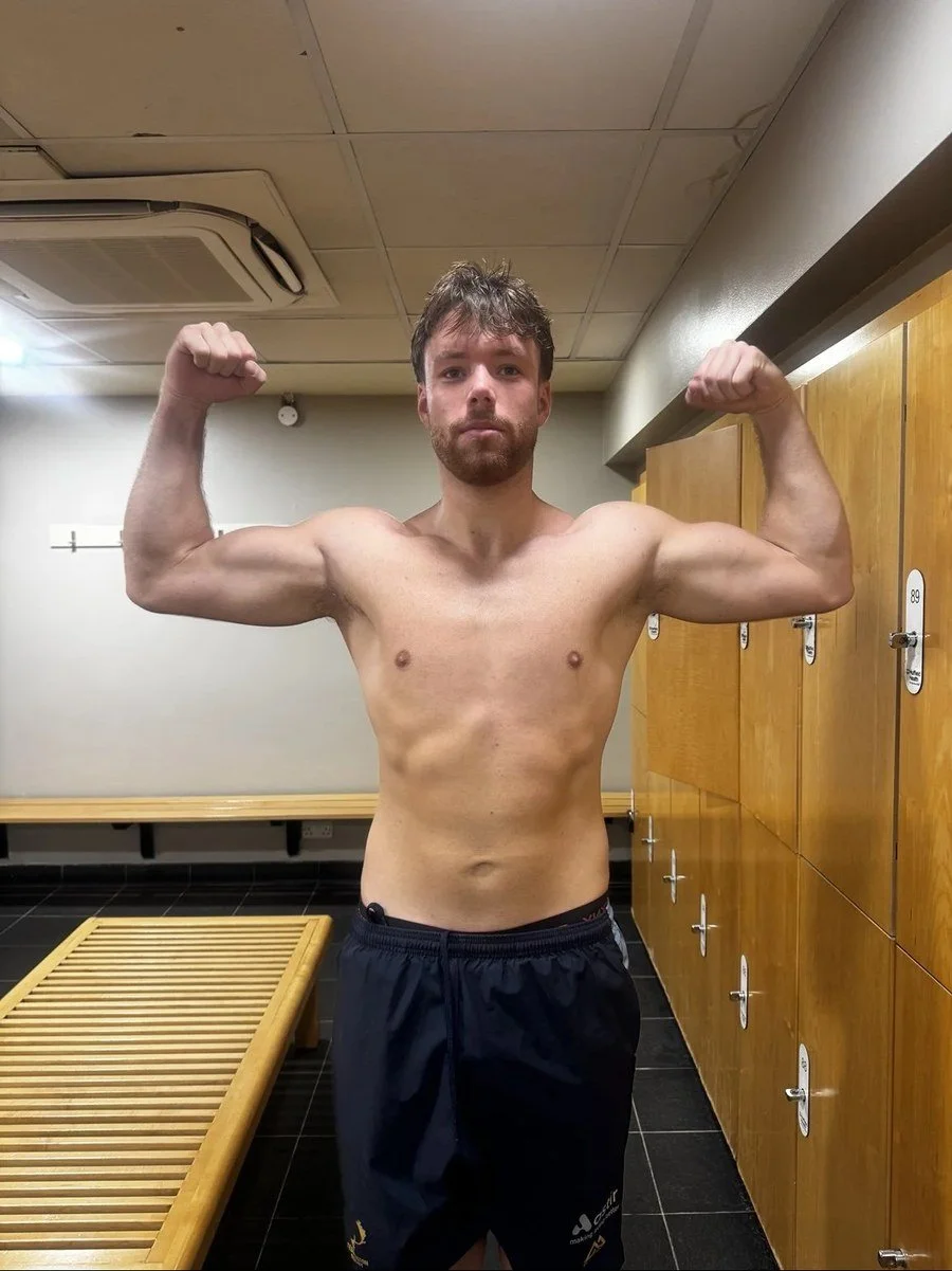 After training with Luke: the same client flexing in a changing room