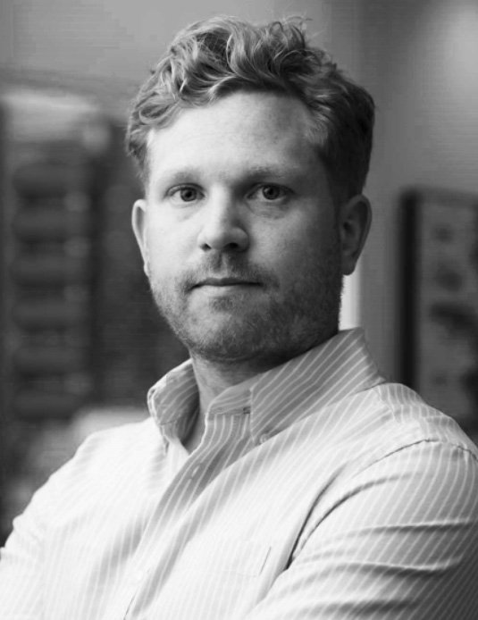 Portrait of a man in black and white, looking at the camera from a 45 degree angle, a business headshot