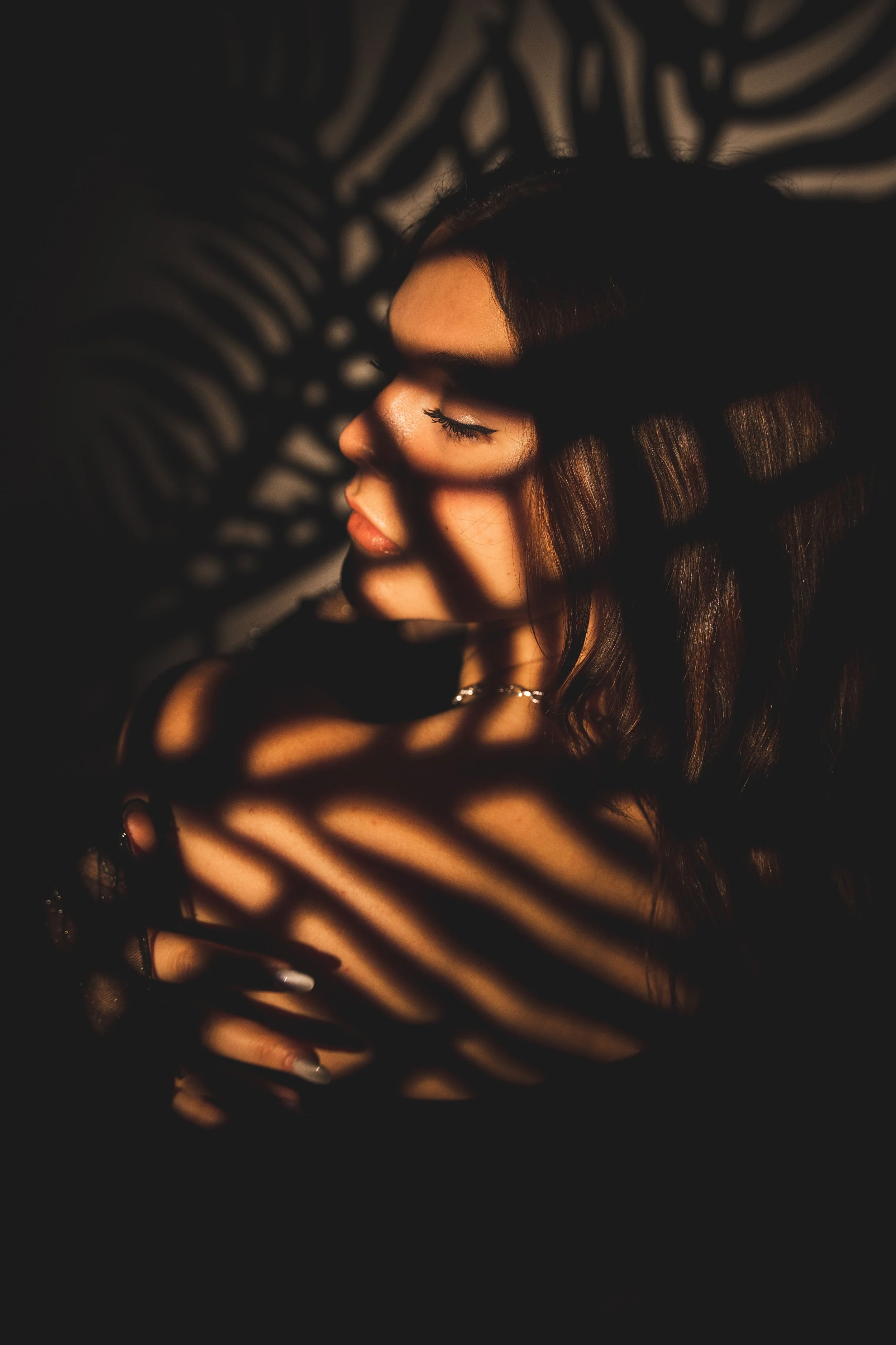 A woman in warm sunlight and deep shadow