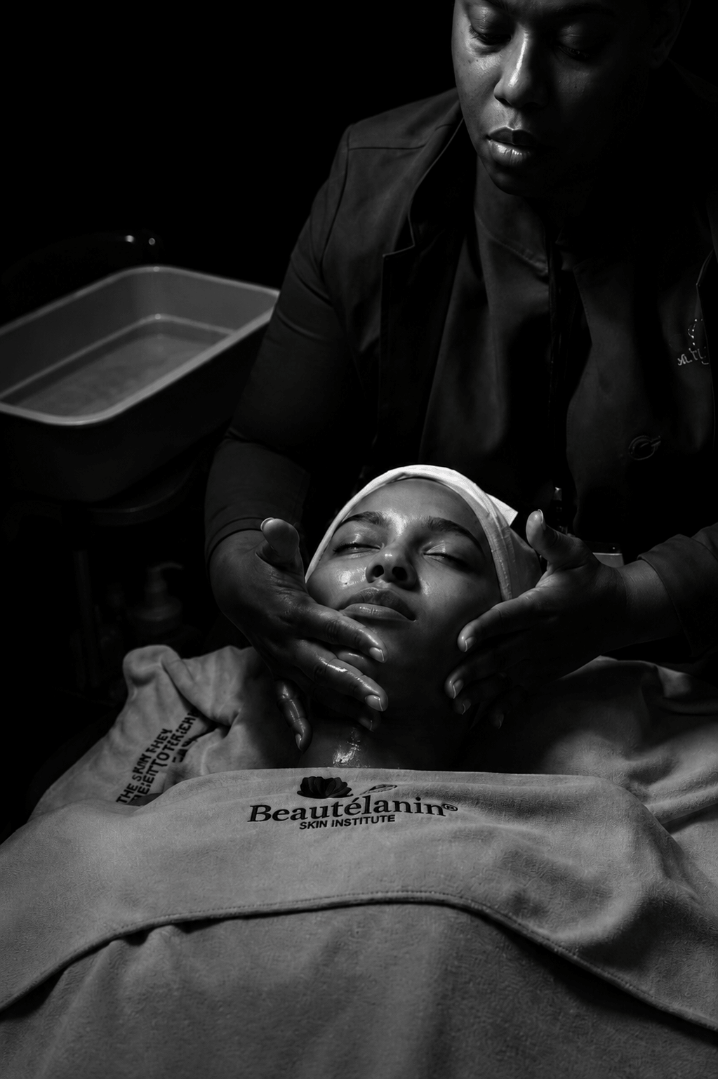 Black and white skincare treatment in dramatic light