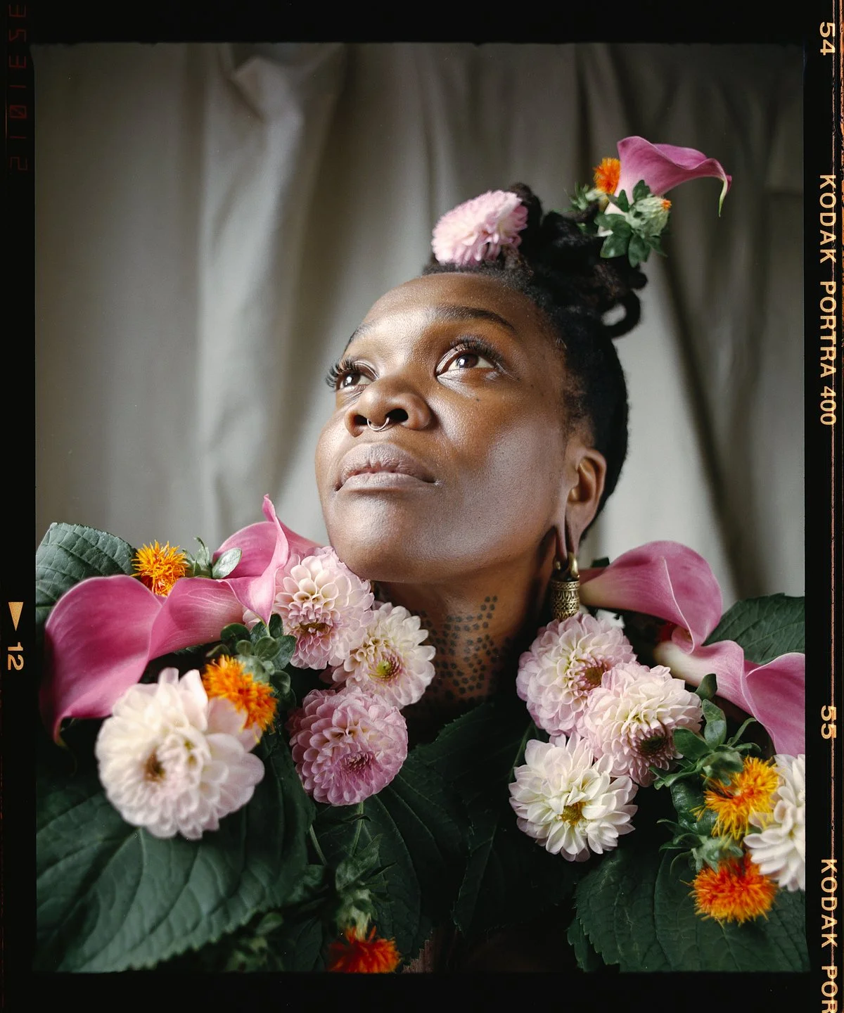 Creative portrait with floral styling and soft daylight
