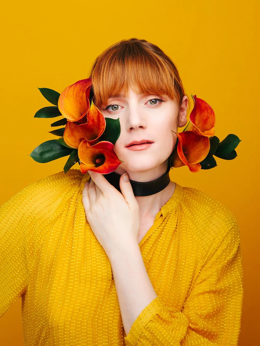 Creative portrait with floral styling, shot in the studio