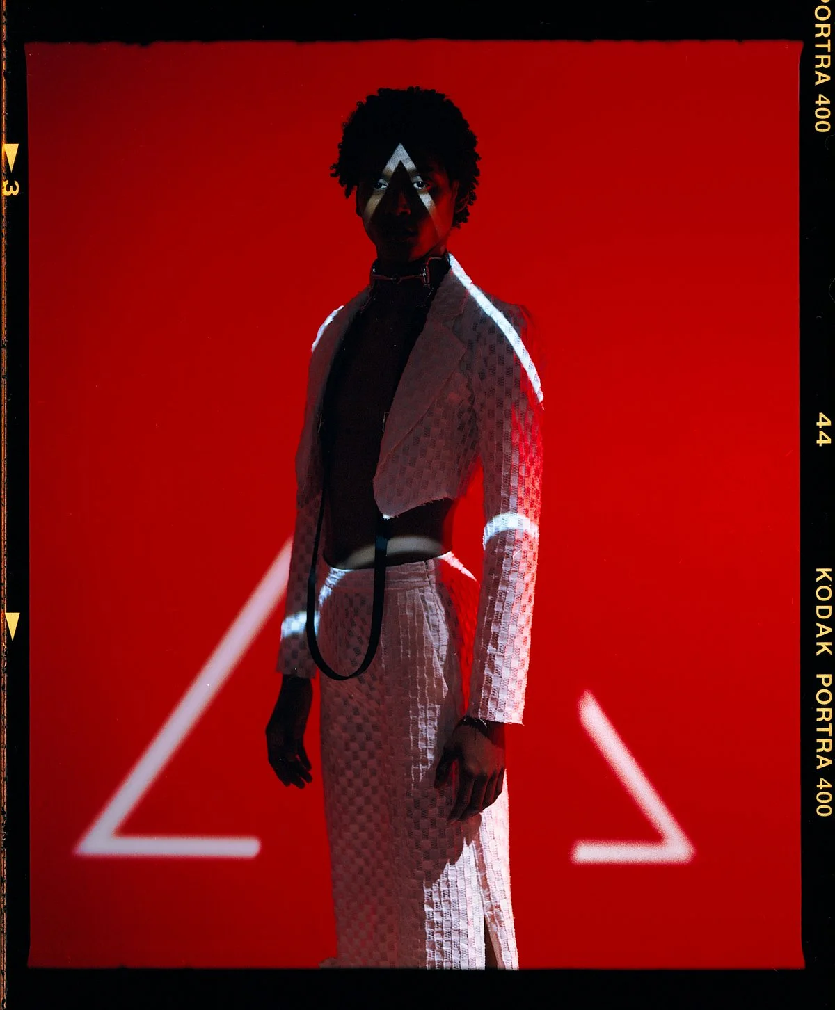 Fashion campaign photography on a red set