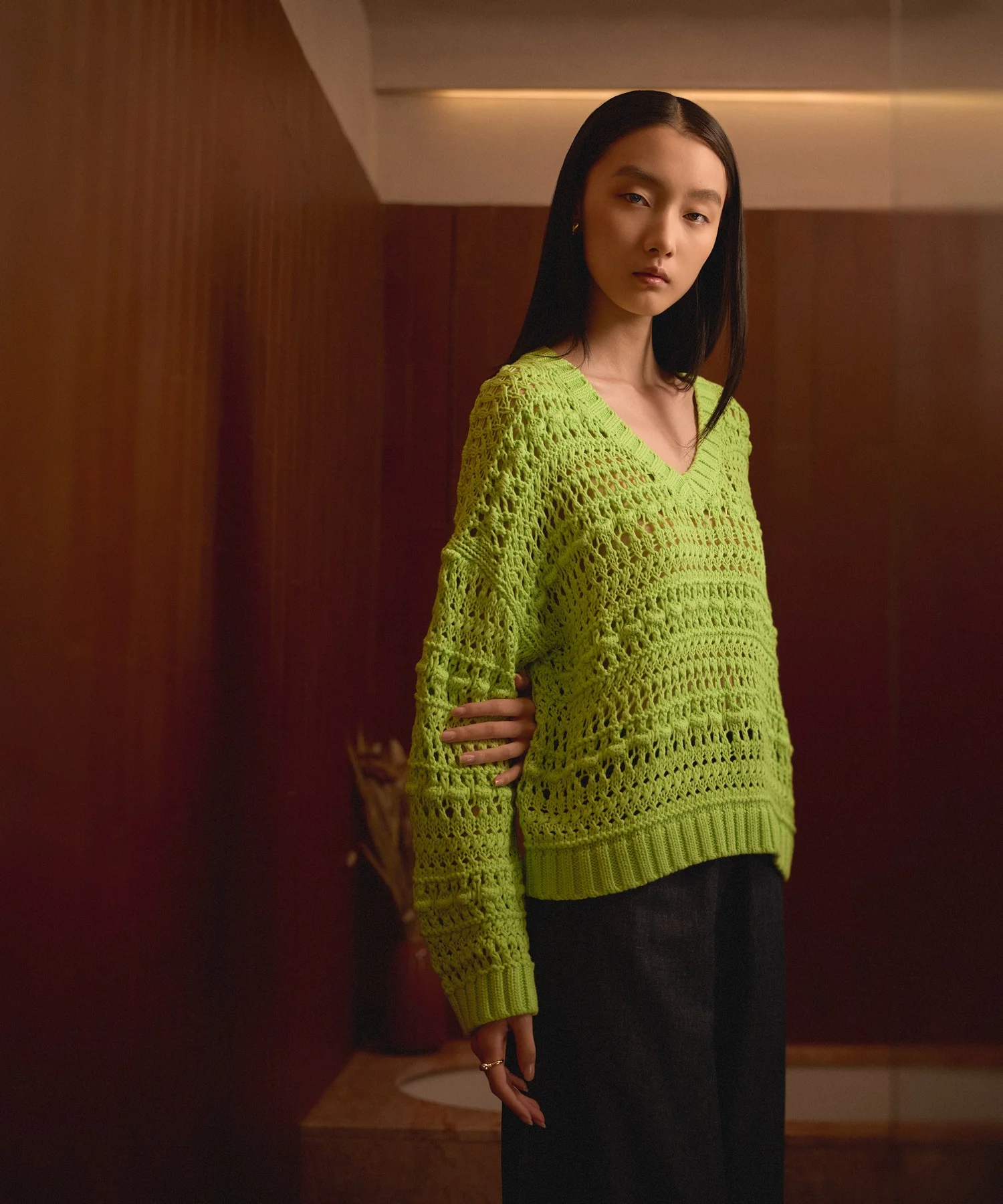 Knitwear lookbook portrait on a green set