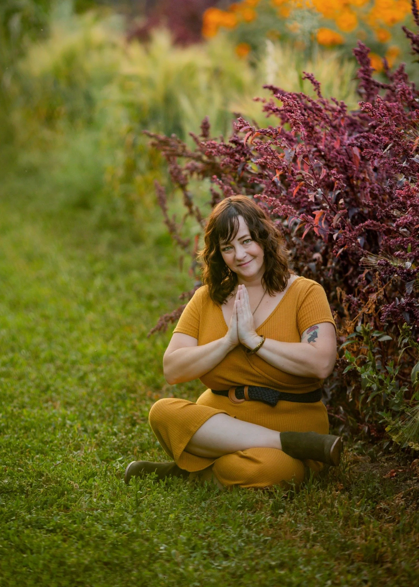 Patrice outdoors in a mustard dress
