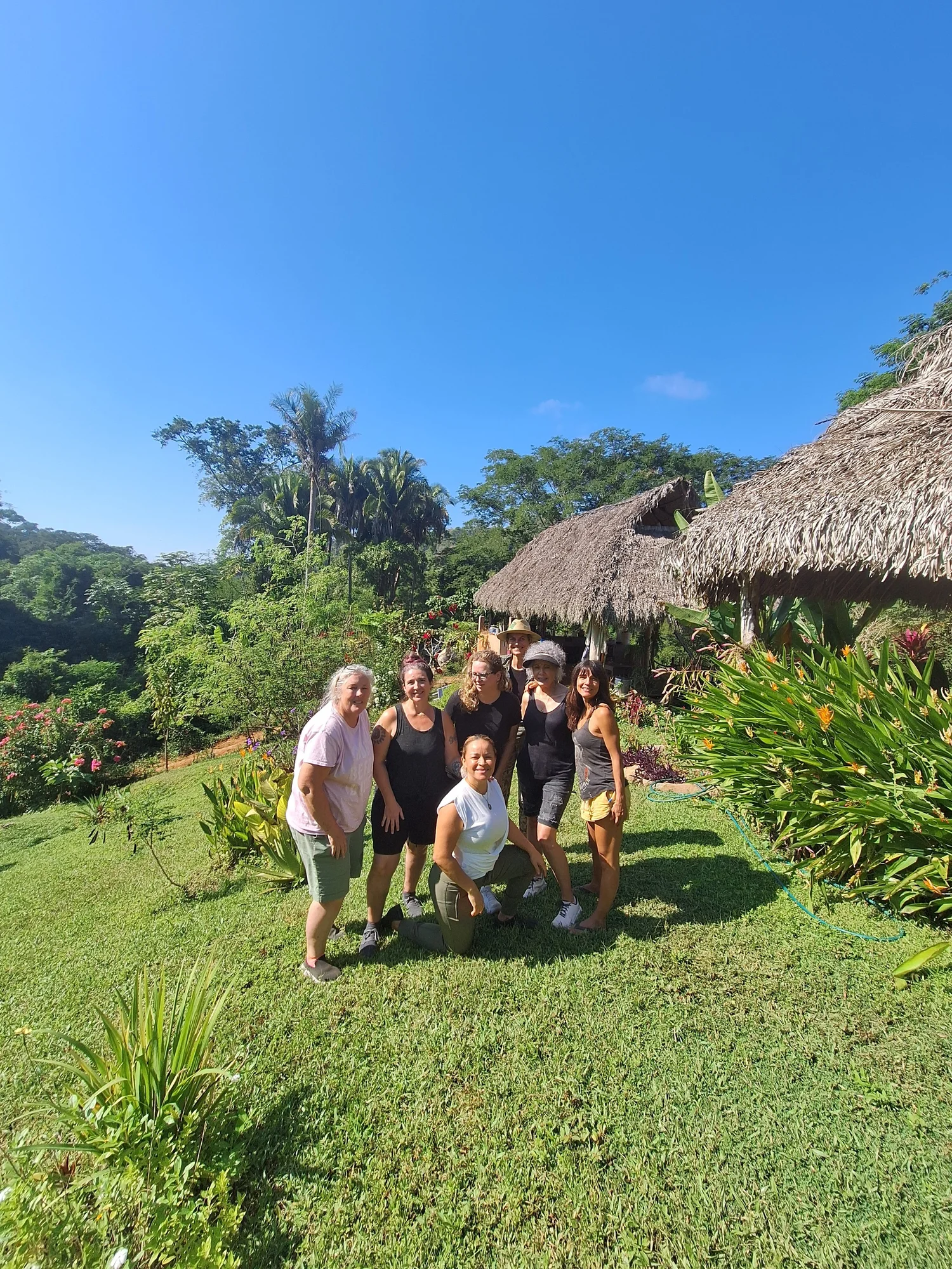 A DEEPEN retreat group smiling in a jungle garden