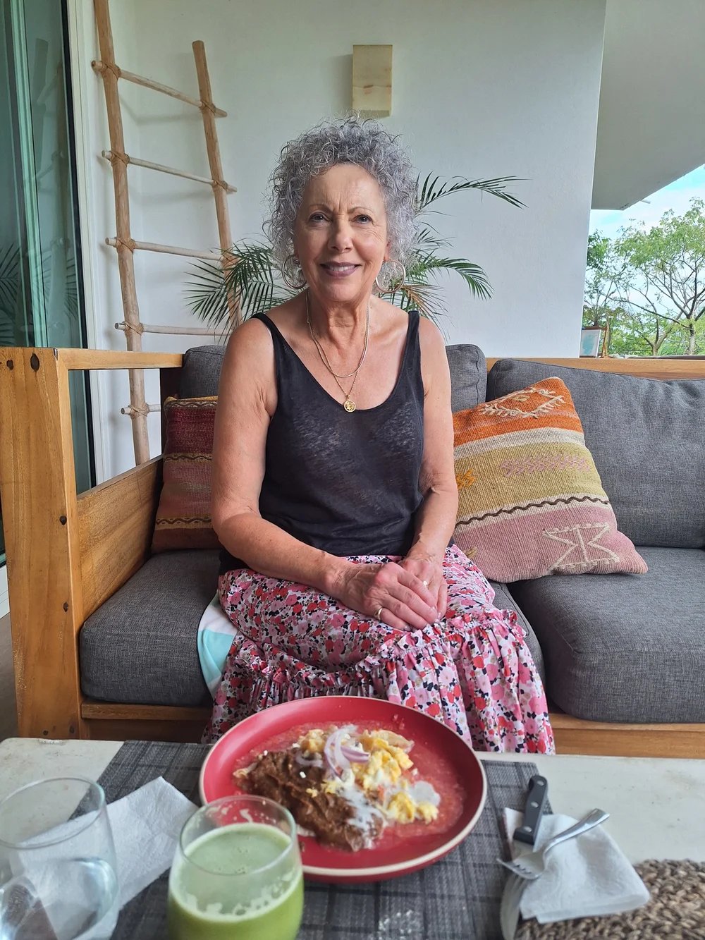 A guest relaxing on the terrace with breakfast