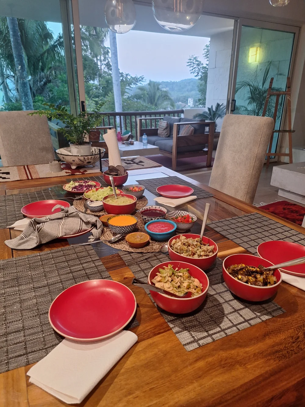 A colourful dinner spread on the table with a view of the hills