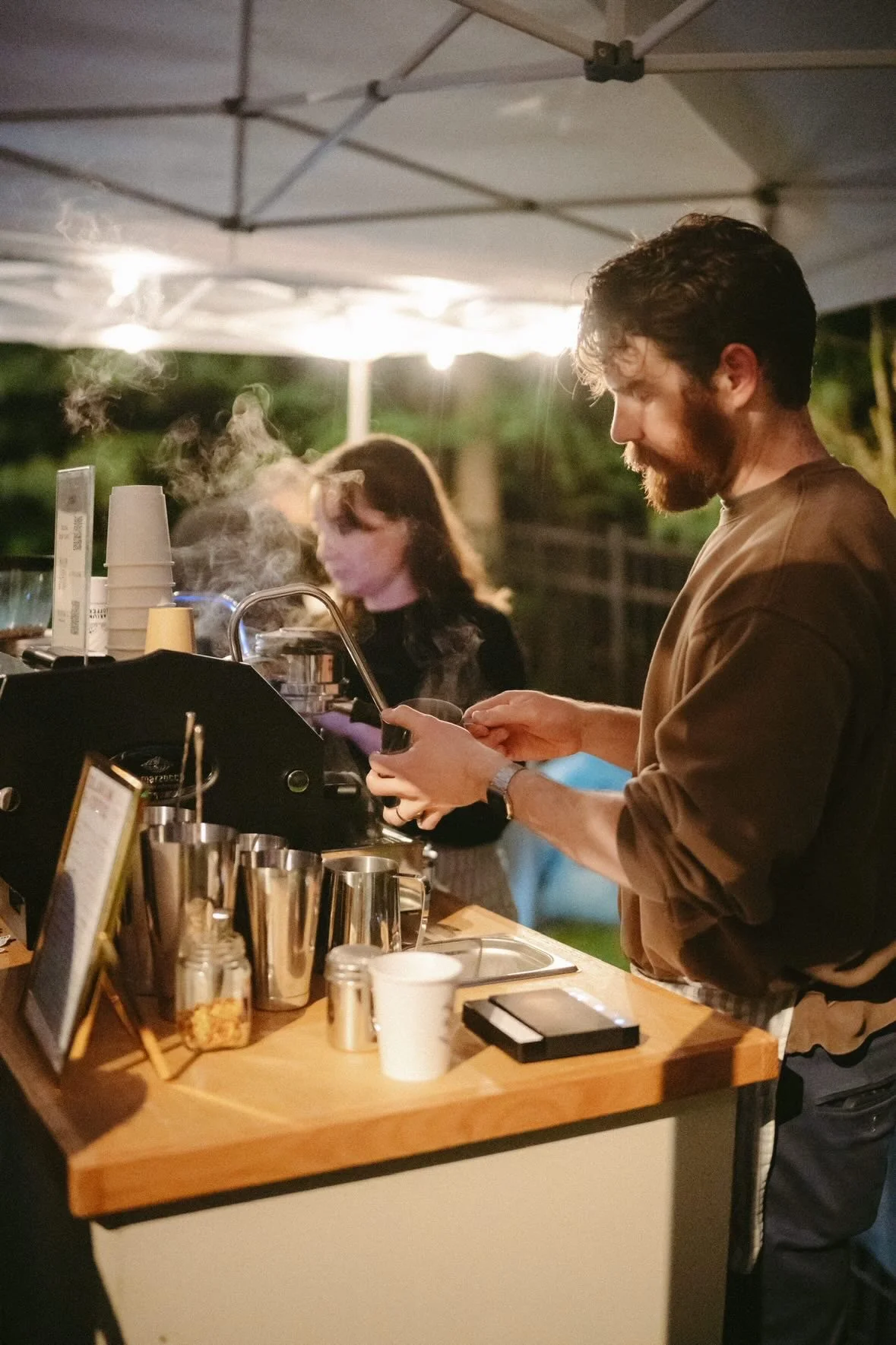 Solarium Coffee espresso cart with a barista serving guests at an event