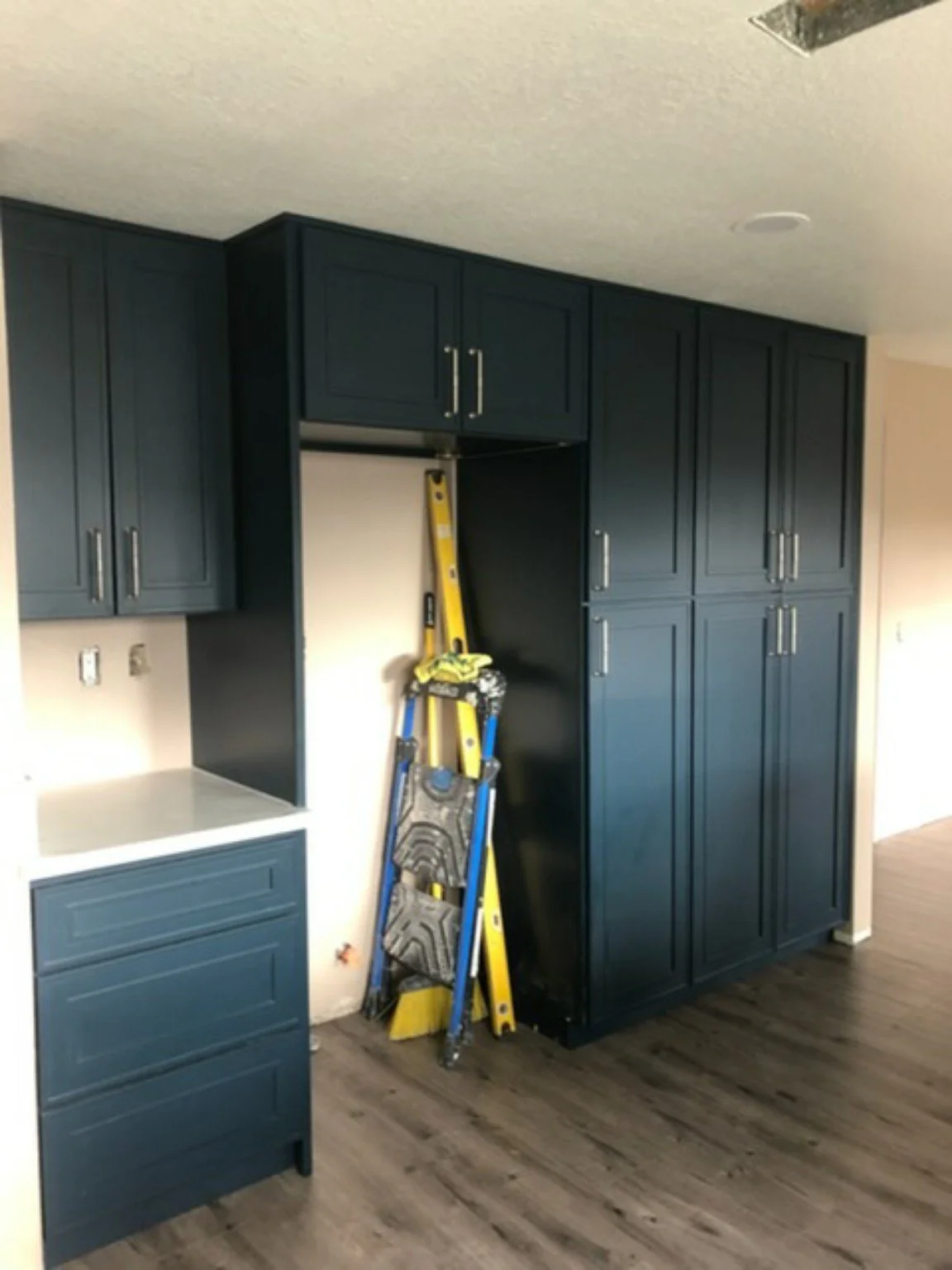 Finished navy kitchen with central island and open living area