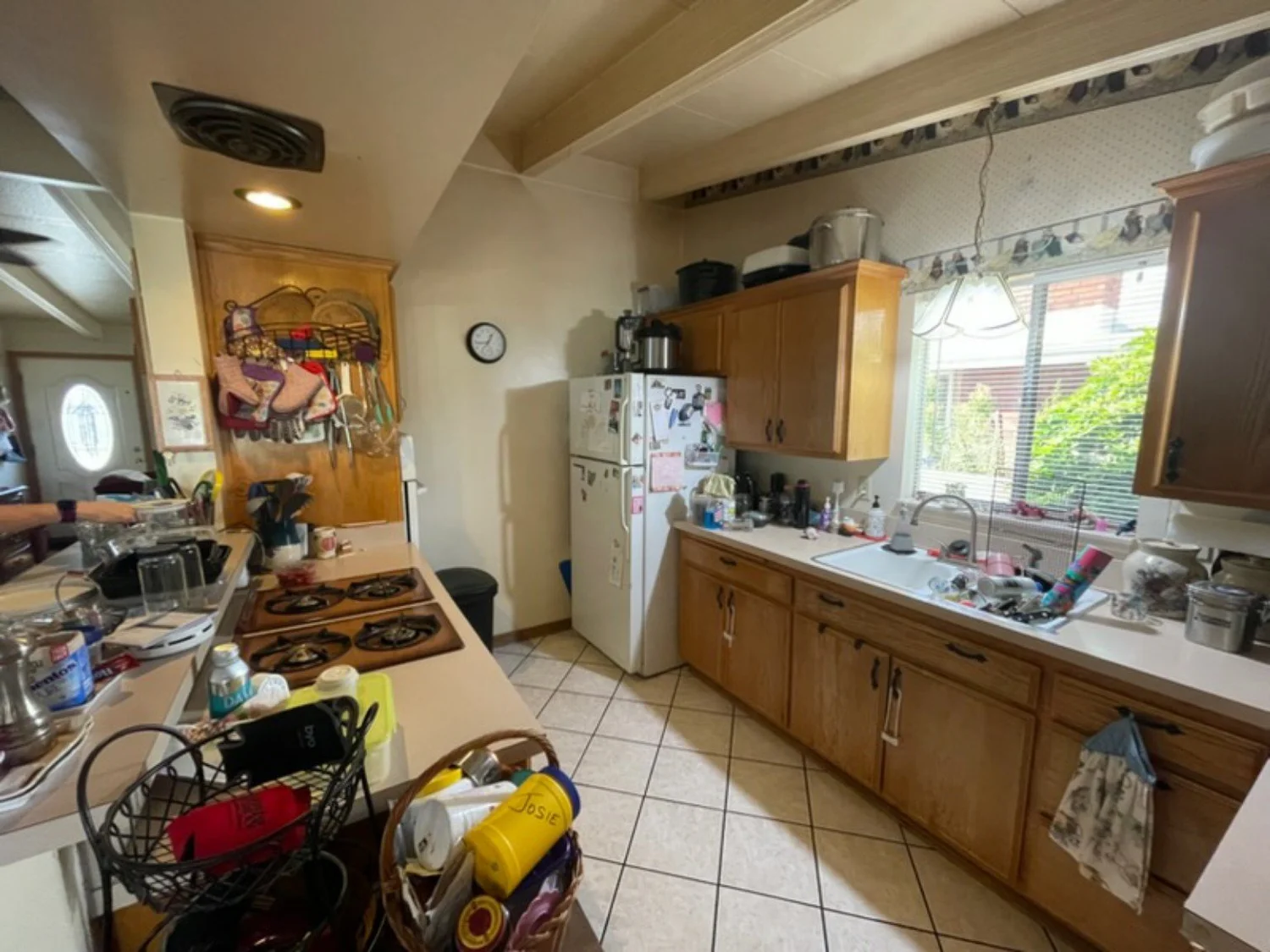 Original warm wood kitchen cabinetry before the update