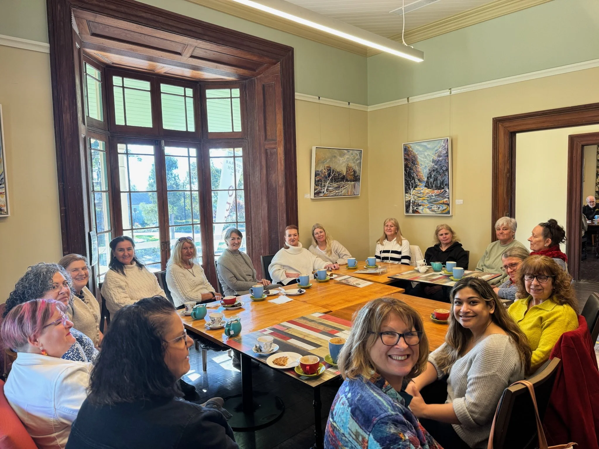 Group gathered around tables for the monthly coffee and chat
