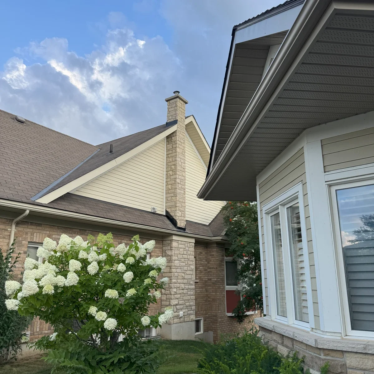 Stone chimney masonry shown above a residential roofline