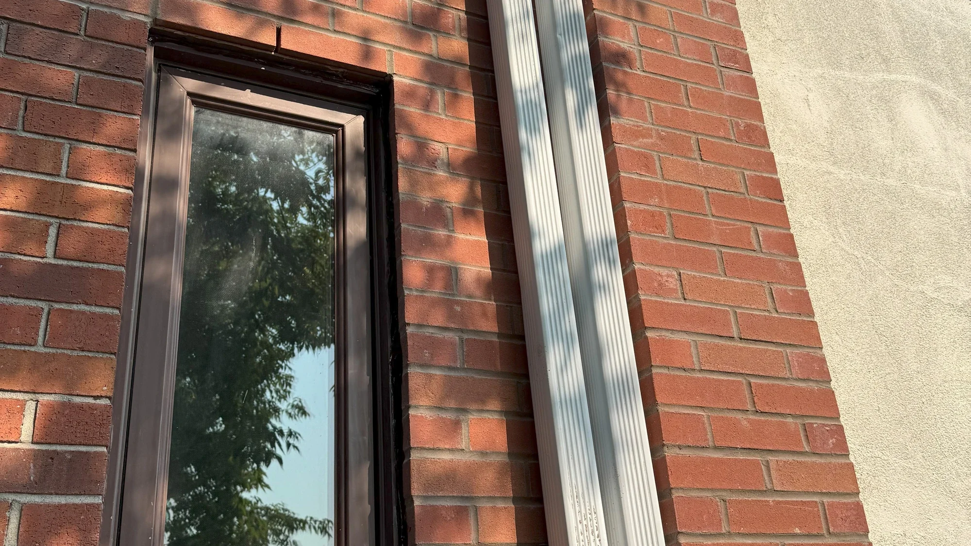 Restored brick wall area around a tall window.
