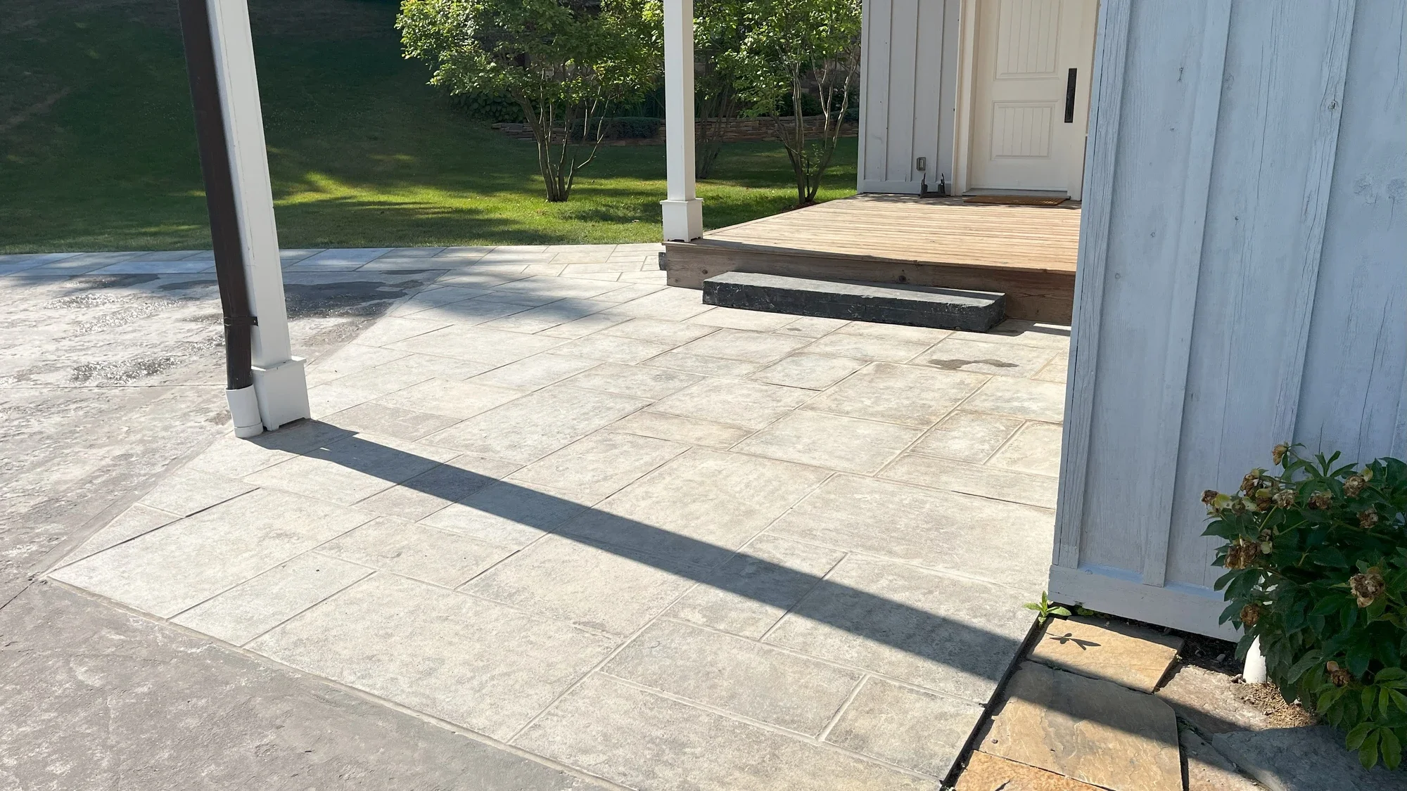 Restored flagstone walkway near a residential entrance.