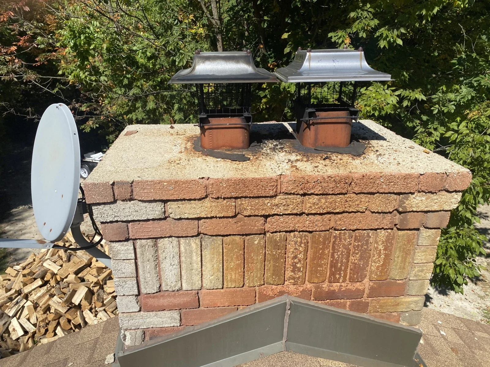 Brick chimney top with cap and flue context.