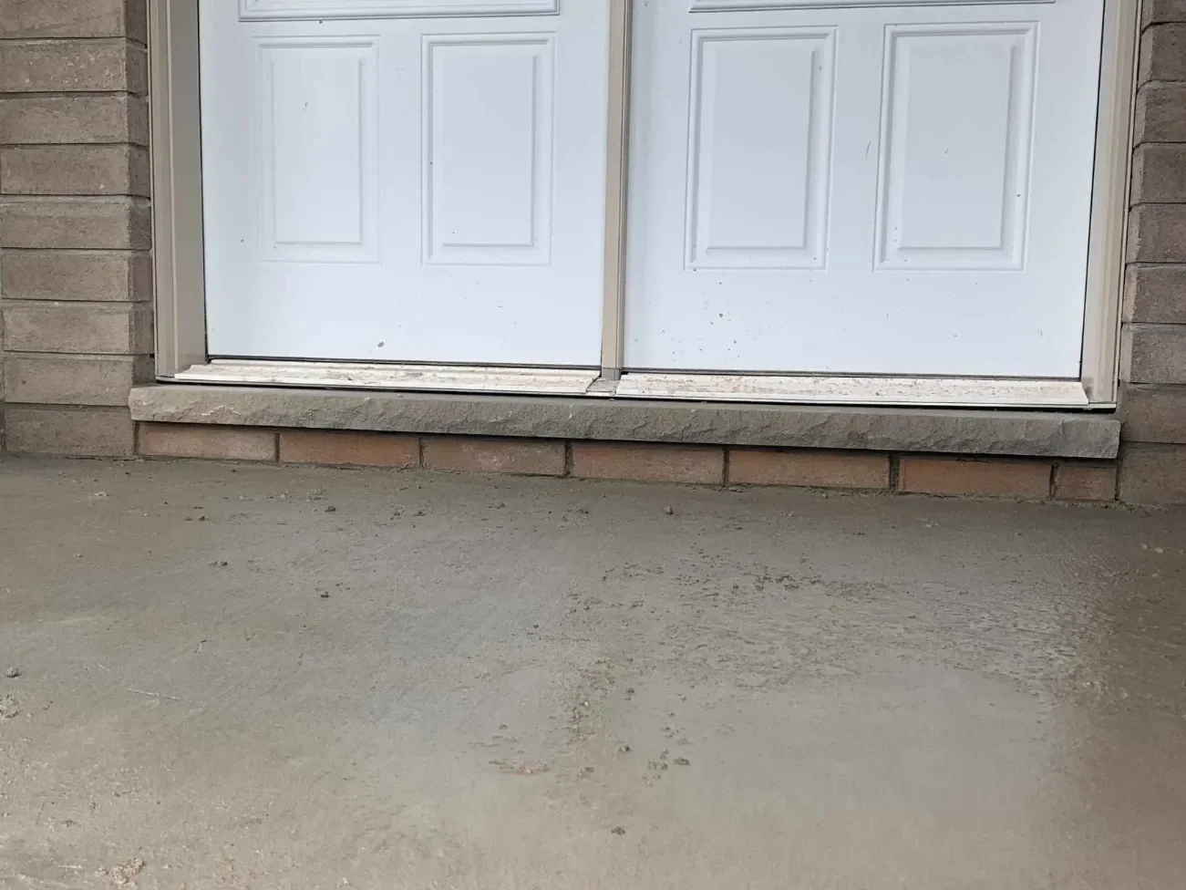 Exterior door sill replacement with surrounding masonry context.