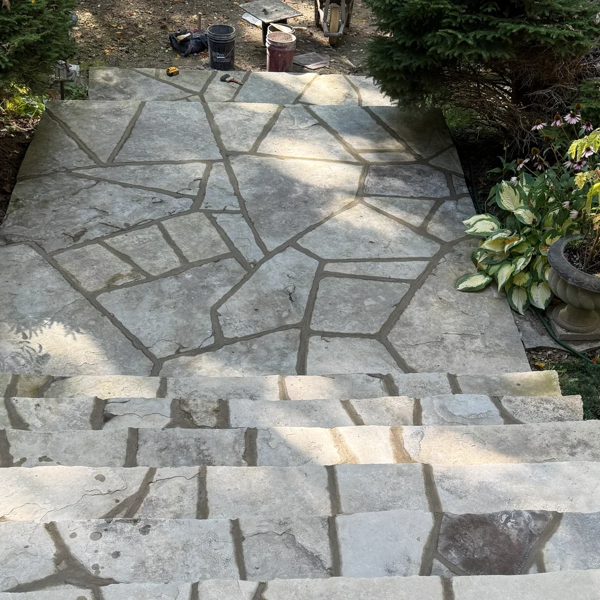 Flagstone walkway and steps through a landscaped entrance