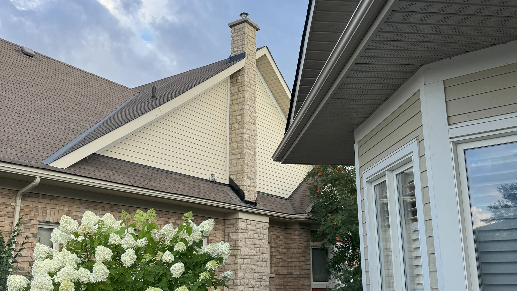 Stone chimney masonry shown above a residential roofline.