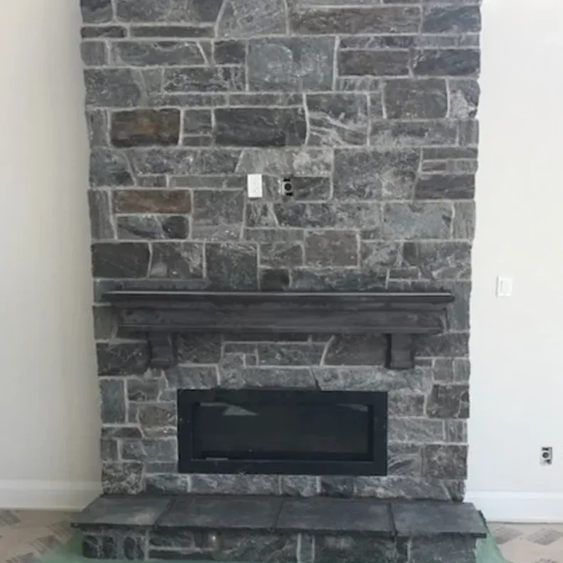 Interior thin stone fireplace with hearth and surround detail