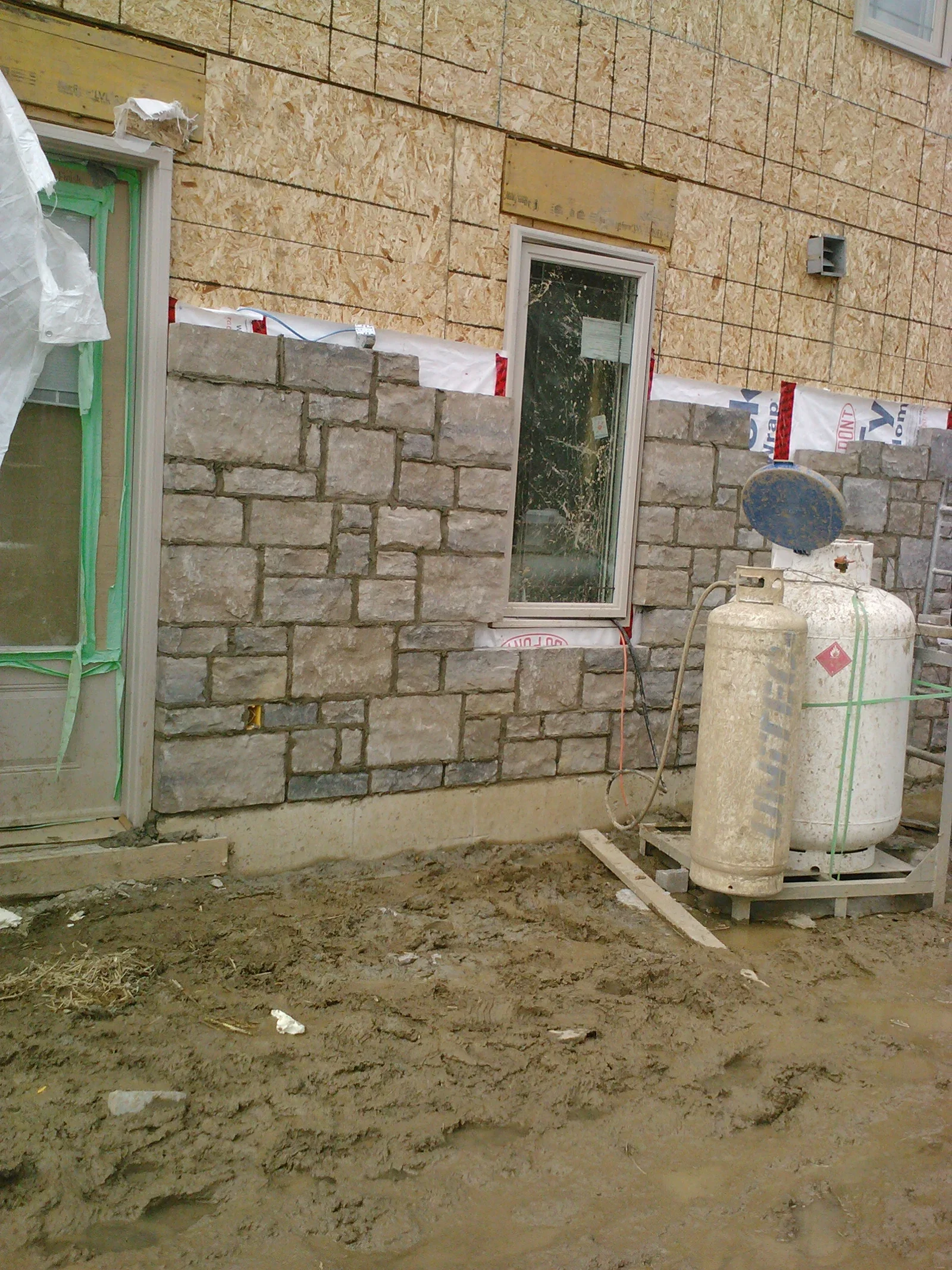 Engineered stone installation at a residential wall area.