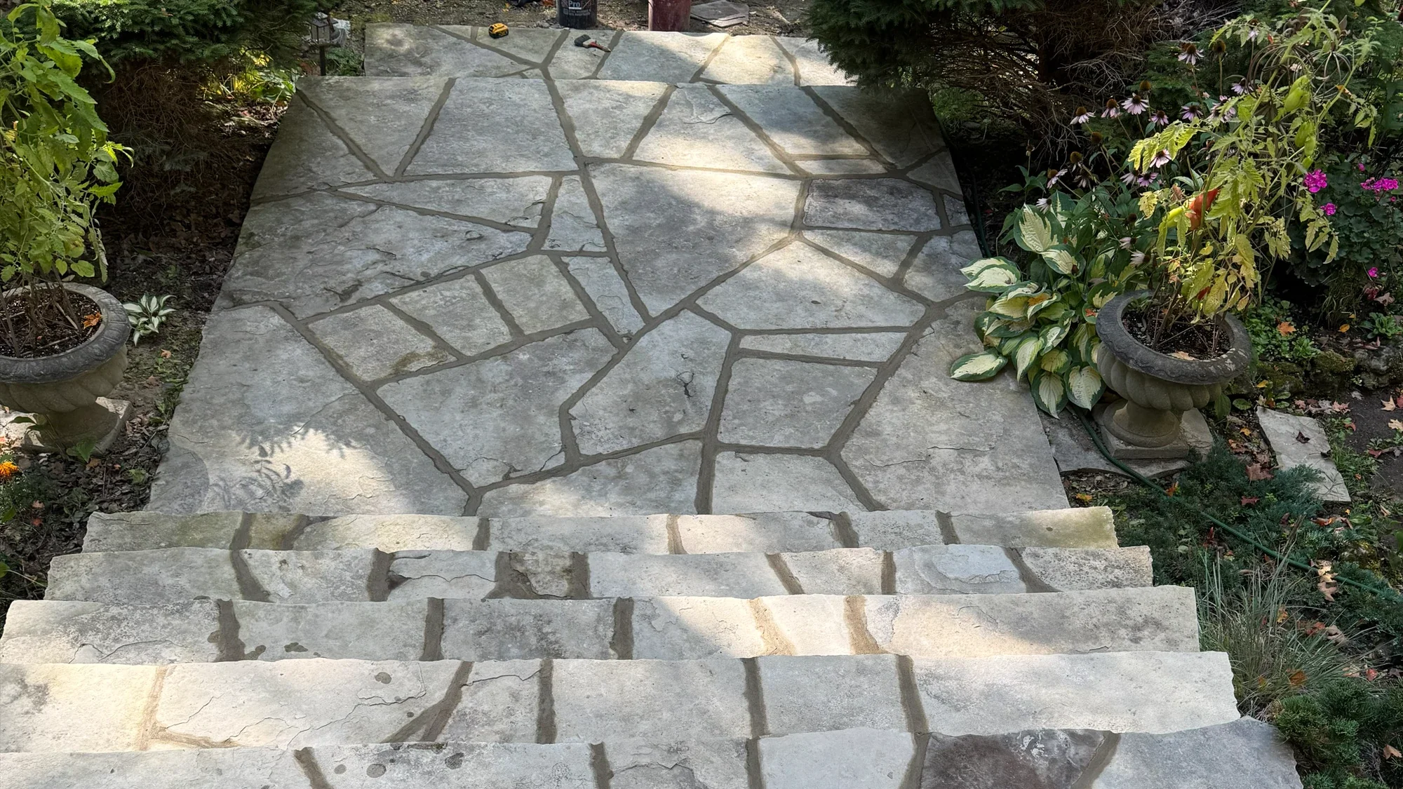 Flagstone walkway and steps through a landscaped entrance.
