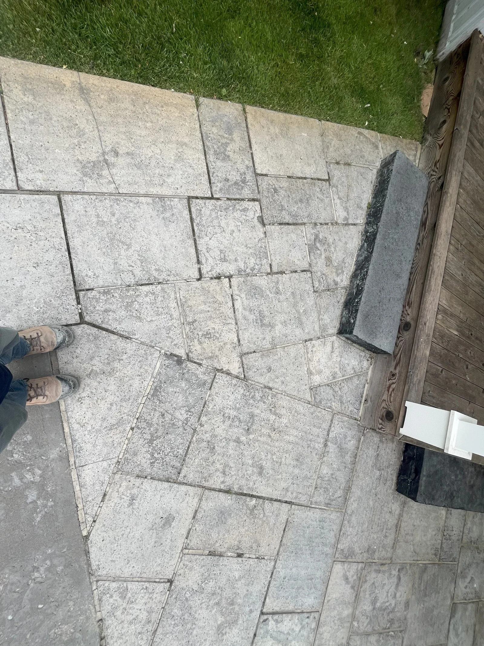Flagstone walkway with eroded joints before repair work.