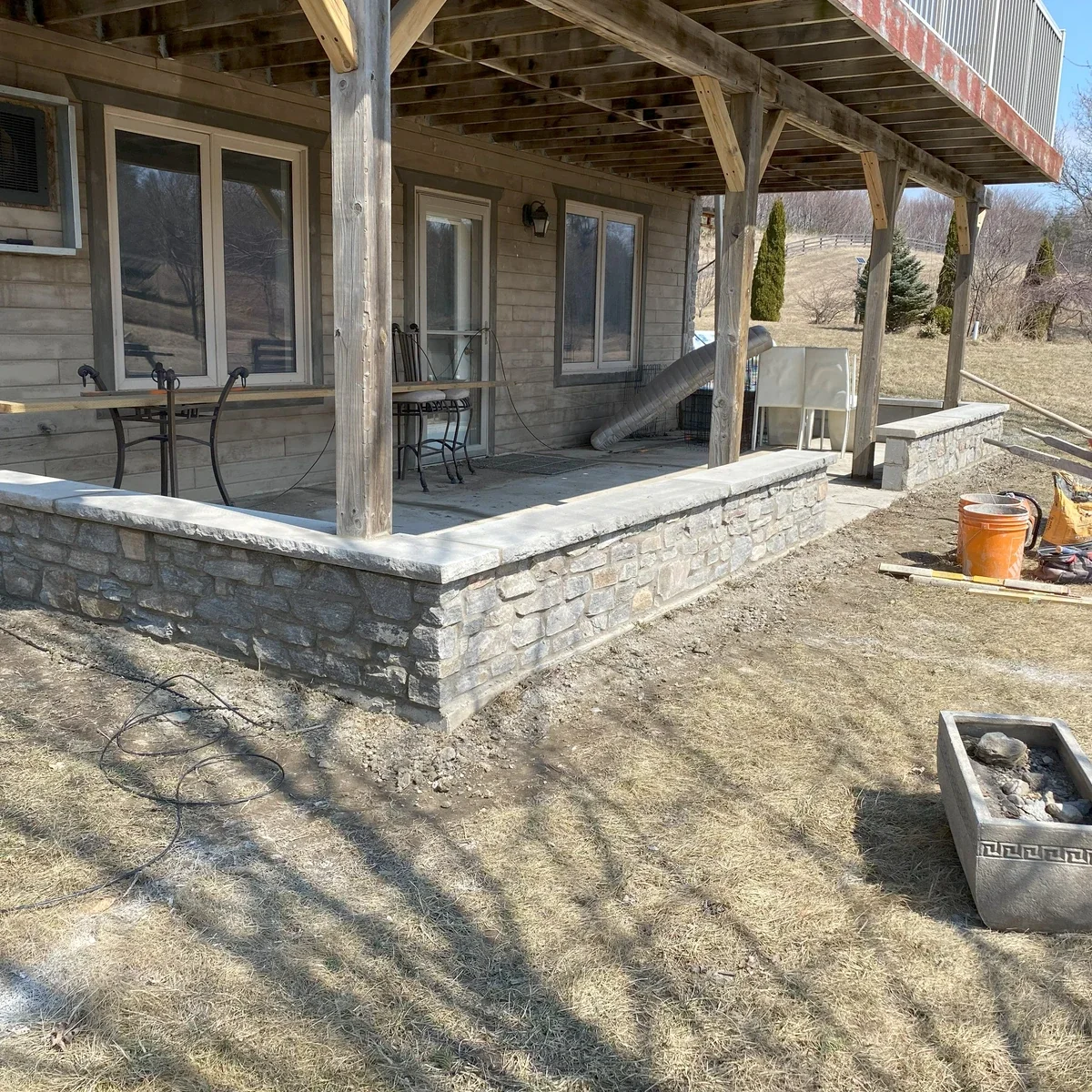 Stone foundation and porch masonry work in residential context