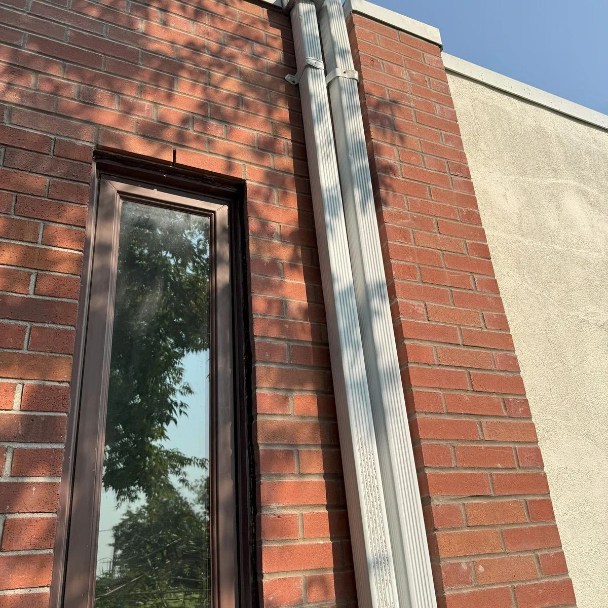 Restored brick wall area around a tall window