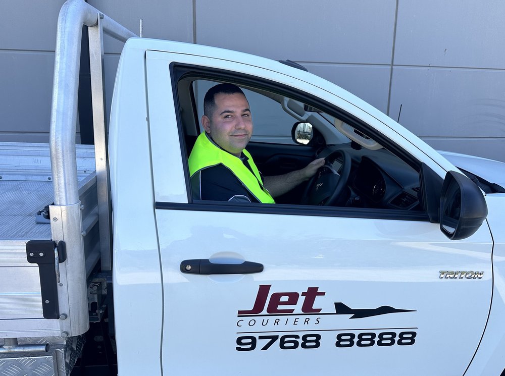 Jet Couriers Owner Driver seated in his branded courier vehicle