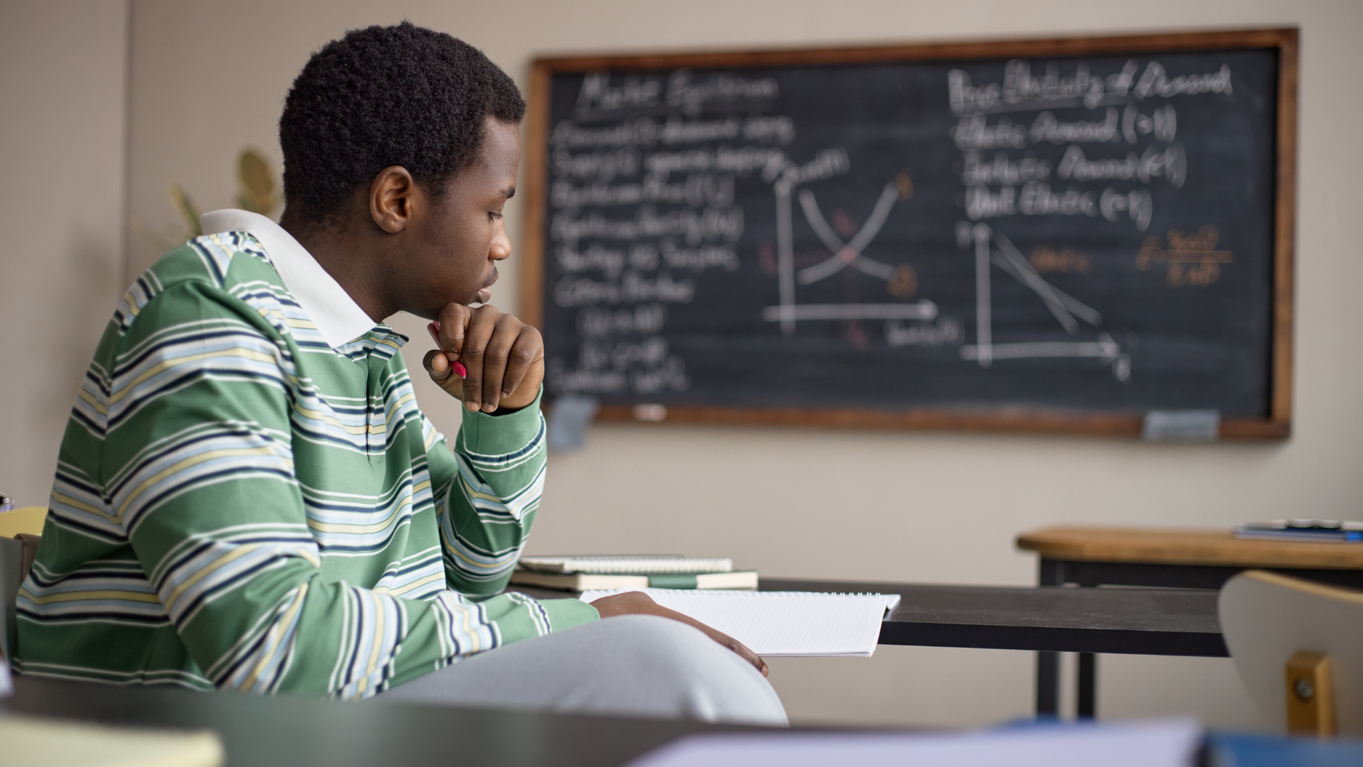 A student studying in a classroom.
