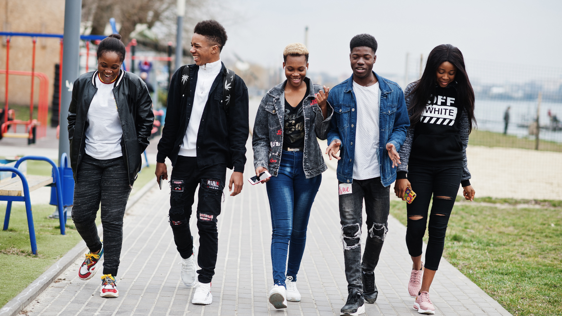 A group of young people walking together outdoors.