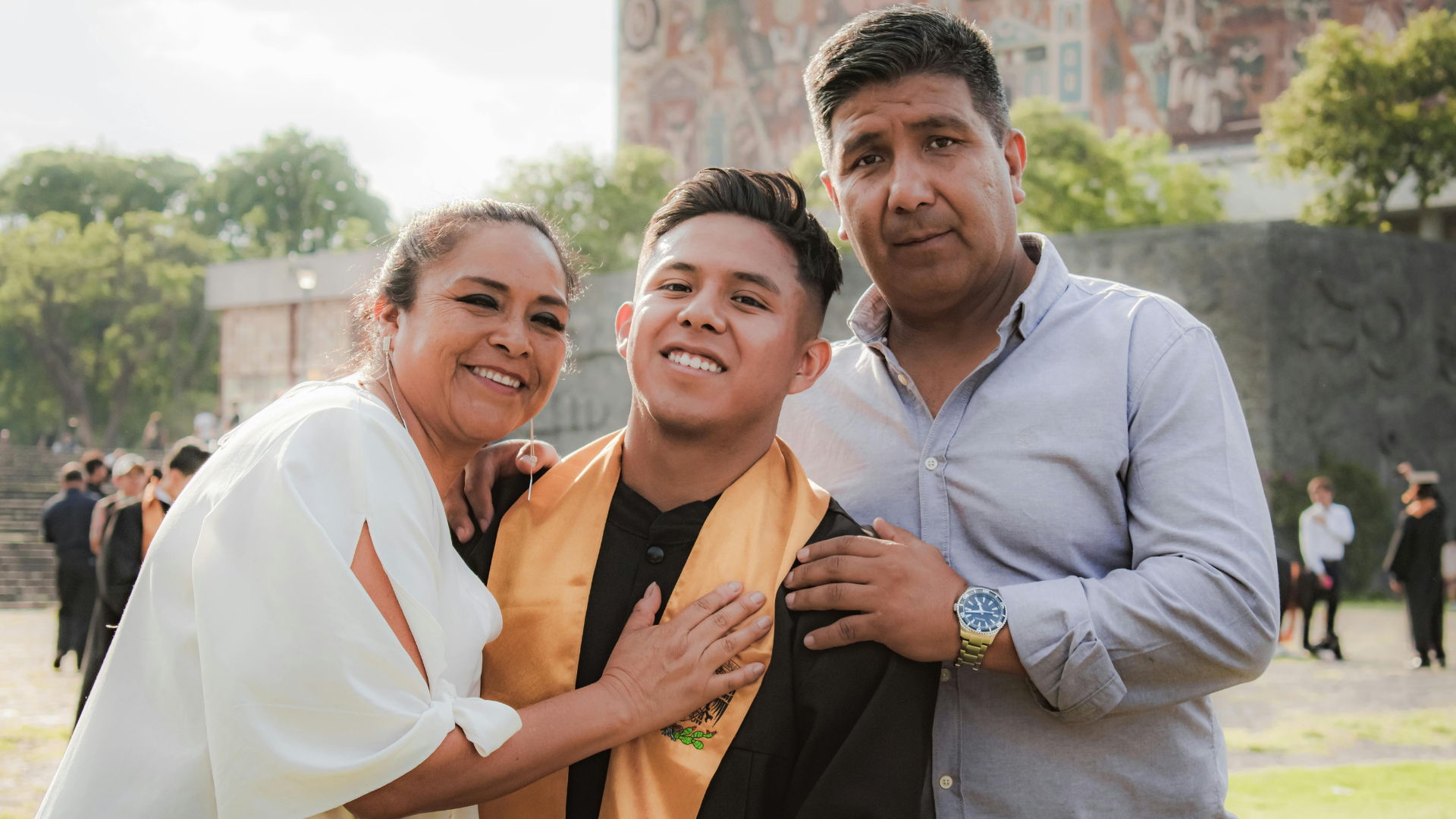 A graduate celebrating with family