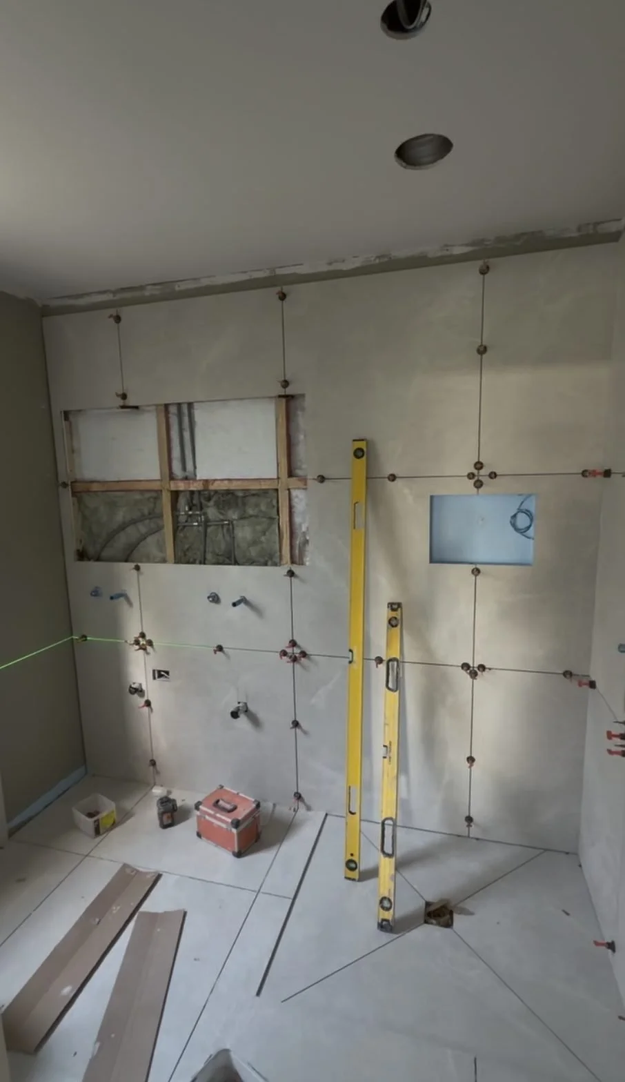 Plumbing and electrical rough-in set out on a laser line in the Greenhithe master bathroom renovation