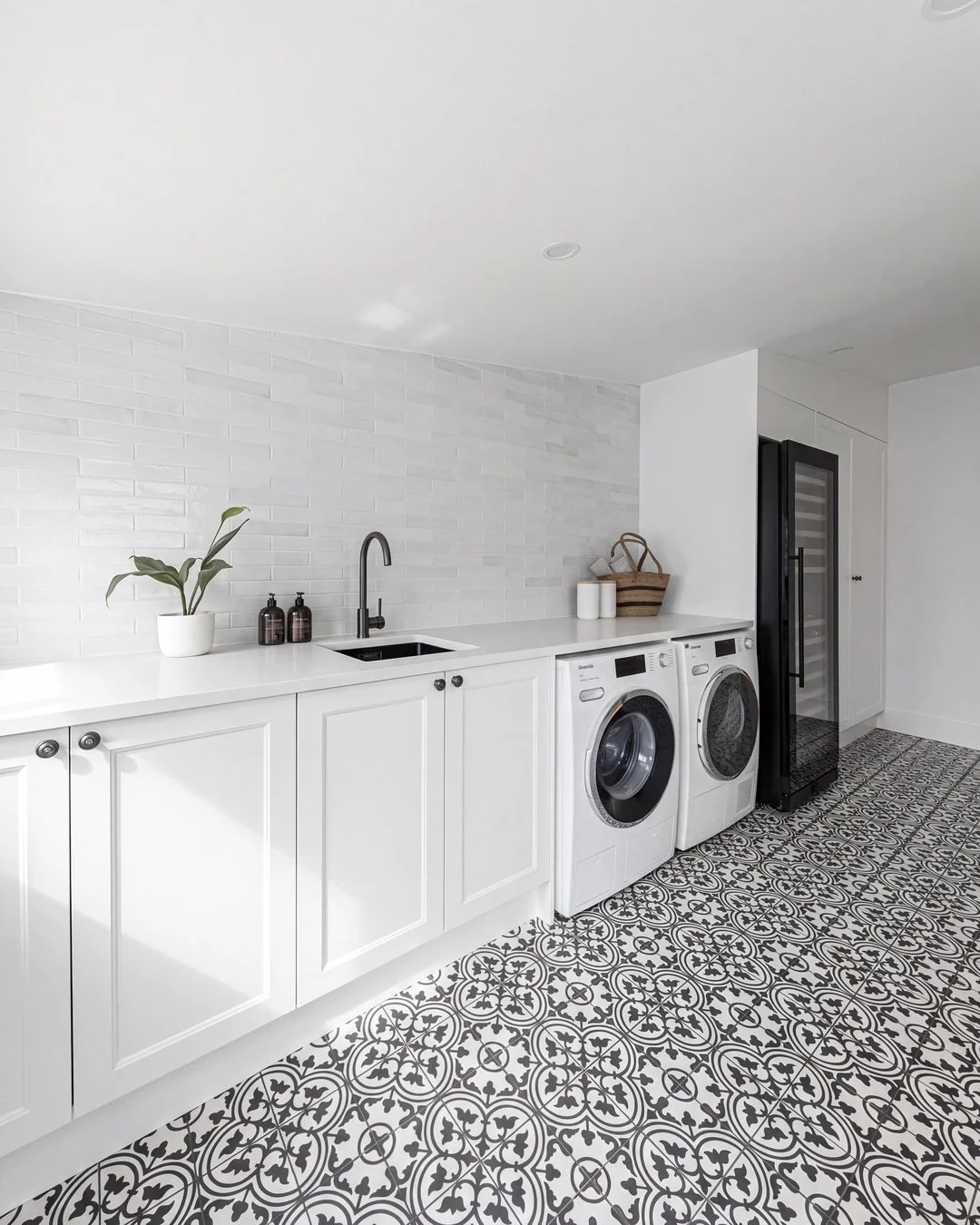 Finished galley laundry renovation on Seymour Street, St Marys Bay, with white shaker cabinetry and encaustic floor tile